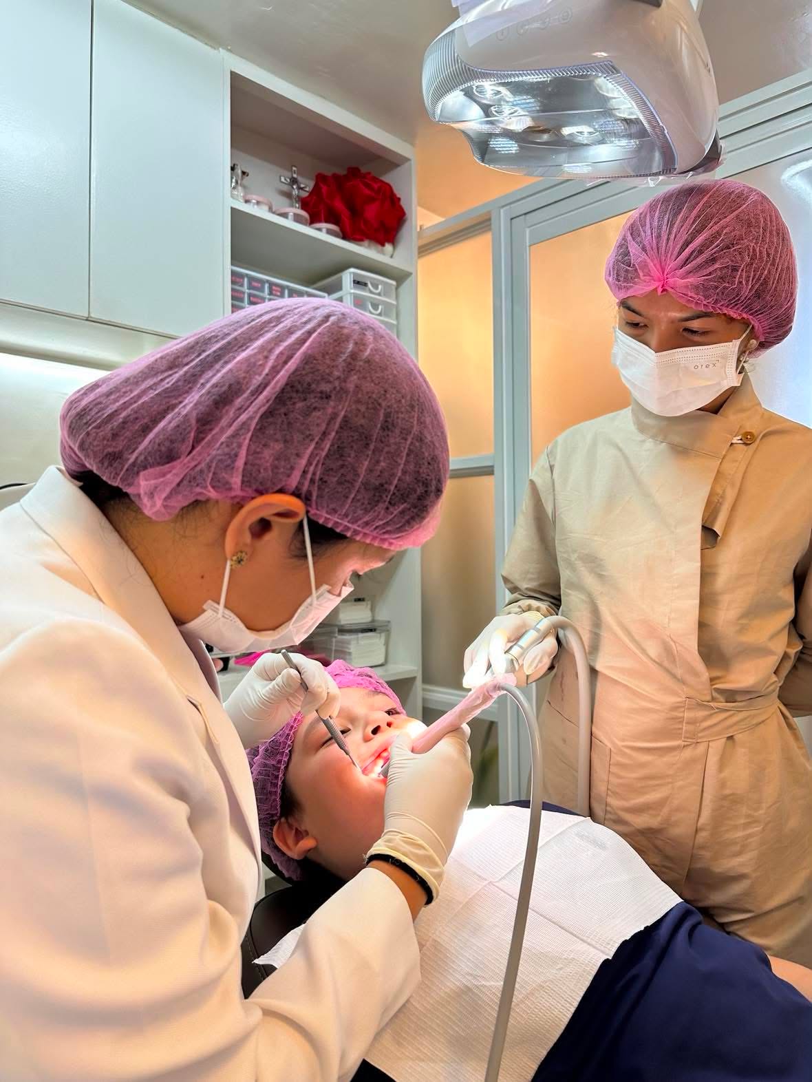 Dental care team performing a procedure at The A+ Dental Clinic